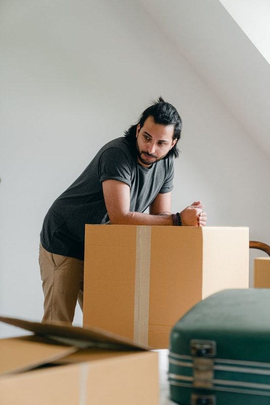 UW Moving mover lifting a packed carton